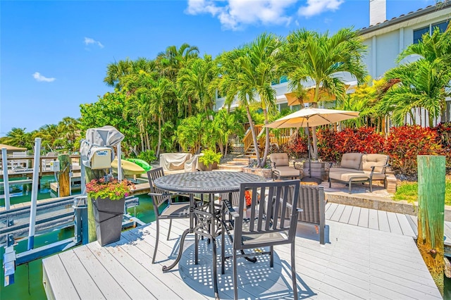 903 Pinellas Bayway S Unit 103, Tierra Verde, FL 33715 - deck with an outdoor living space, a dock, and boat lift
