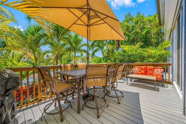 903 Pinellas Bayway S Unit 103, Tierra Verde, FL 33715 - wooden terrace with outdoor dining space