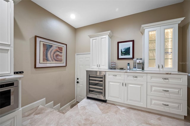 903 Pinellas Bayway S Unit 103, Tierra Verde, FL 33715 - indoor bar with beverage cooler, stainless steel oven, baseboards, and recessed lighting