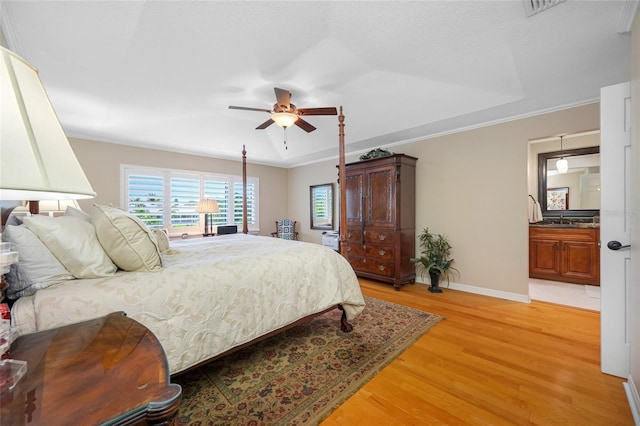 903 Pinellas Bayway S Unit 103, Tierra Verde, FL 33715 - bedroom featuring light wood-style flooring, baseboards, a sink, a ceiling fan, and ornamental molding