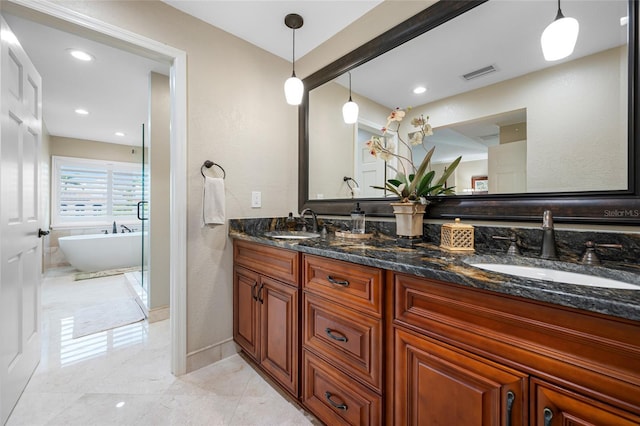 903 Pinellas Bayway S Unit 103, Tierra Verde, FL 33715 - full bathroom featuring double vanity, a freestanding tub, recessed lighting, and baseboards