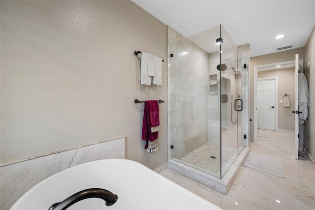 903 Pinellas Bayway S Unit 103, Tierra Verde, FL 33715 - bathroom featuring a soaking tub, a stall shower, recessed lighting, and baseboards