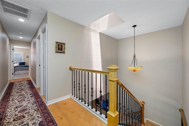 903 Pinellas Bayway S Unit 103, Tierra Verde, FL 33715 - corridor with an upstairs landing, wood finished floors, recessed lighting, and baseboards