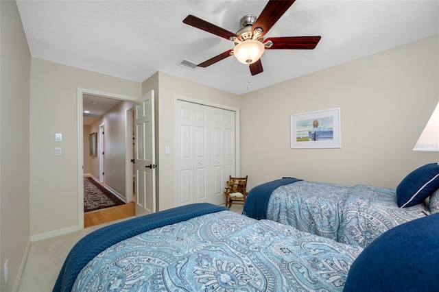 903 Pinellas Bayway S Unit 103, Tierra Verde, FL 33715 - carpeted bedroom featuring a closet, baseboards, and a ceiling fan