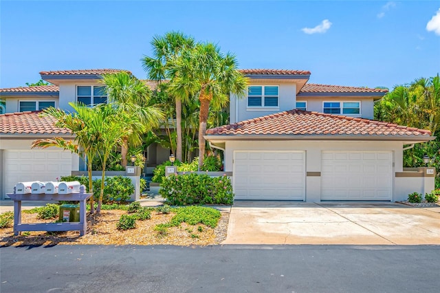 903 Pinellas Bayway S Unit 103, Tierra Verde, FL 33715 - mediterranean / spanish house featuring a tile roof, stucco siding, and driveway