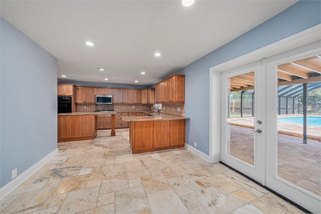 2309 Cypress Walk Way, Ruskin, FL 33570 - kitchen featuring stainless steel microwave, oven, baseboards, stone tile floors, and recessed lighting