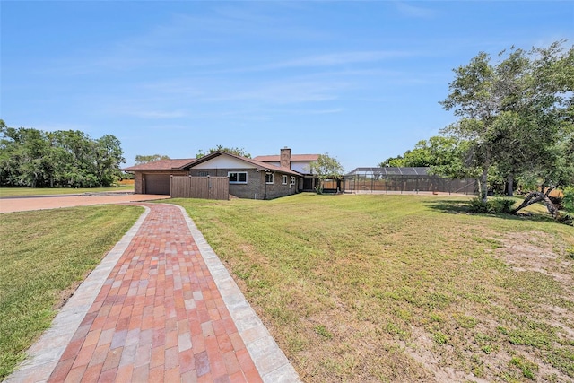 2309 Cypress Walk Way, Ruskin, FL 33570 - view of front of property featuring an attached garage, driveway, and a chimney