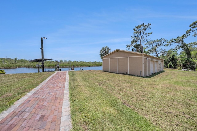 2309 Cypress Walk Way, Ruskin, FL 33570 - view of grassy yard with a water view and a detached garage