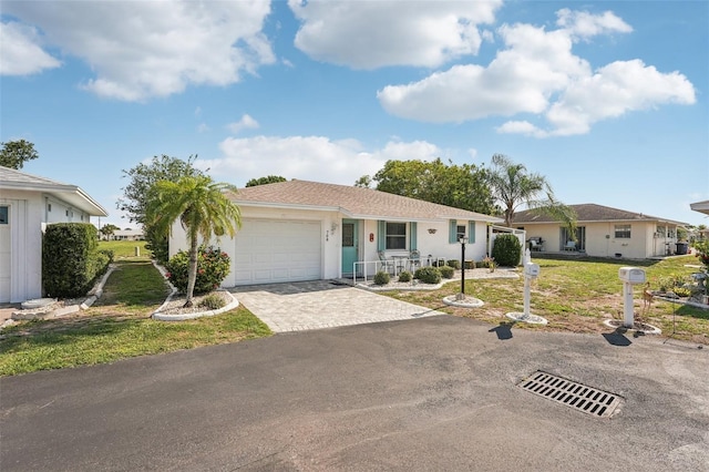 708 Rutgers Pl, Sun City Center, FL 33573 - single story home featuring decorative driveway, a garage, a front yard, stucco siding, and covered porch
