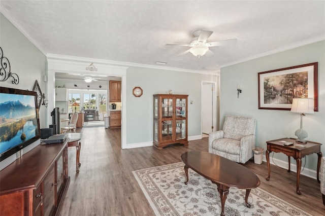 708 Rutgers Pl, Sun City Center, FL 33573 - living area featuring a ceiling fan, wood finished floors, baseboards, and ornamental molding