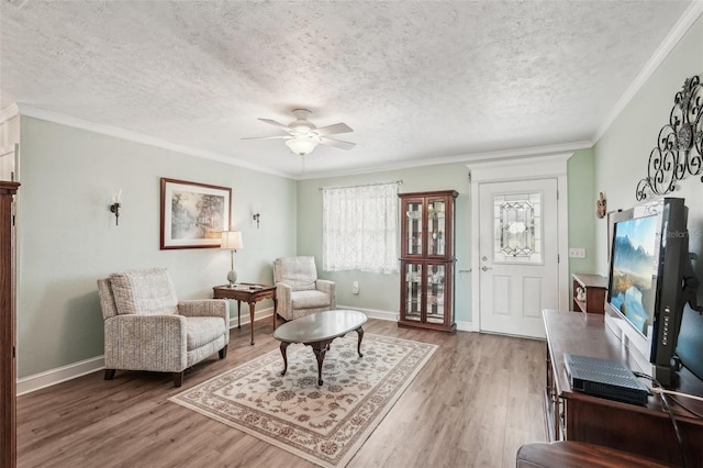 708 Rutgers Pl, Sun City Center, FL 33573 - living room with wood finished floors, a ceiling fan, a textured ceiling, baseboards, and ornamental molding