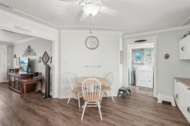 708 Rutgers Pl, Sun City Center, FL 33573 - dining space featuring washer / clothes dryer, crown molding, wood finished floors, ceiling fan, and baseboards