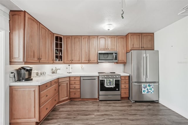 708 Rutgers Pl, Sun City Center, FL 33573 - kitchen with stainless steel appliances, glass insert cabinets, tile countertops, a sink, and a textured ceiling