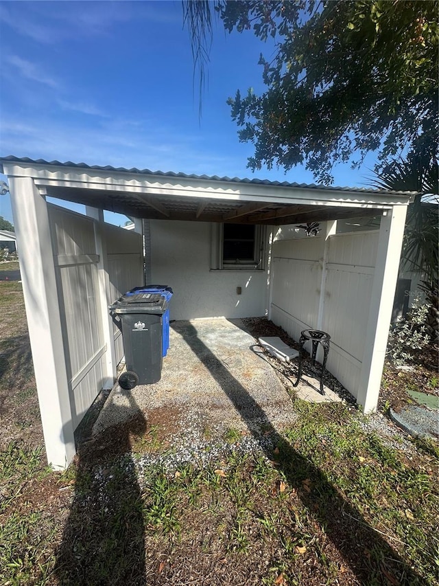 708 Rutgers Pl, Sun City Center, FL 33573 - rear view of property with an attached carport and stucco siding