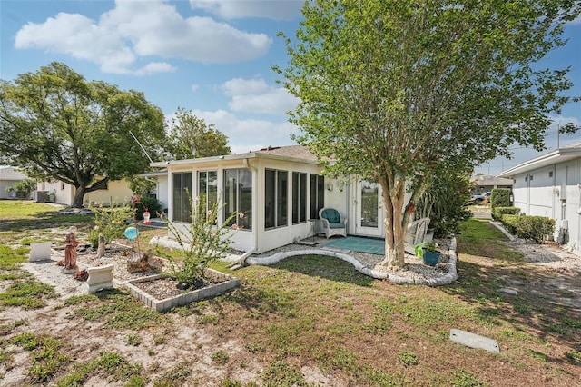 708 Rutgers Pl, Sun City Center, FL 33573 - back of property with a sunroom and a yard