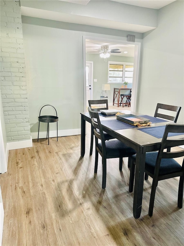 5654 12th St, Zephyrhills, FL 33542 - dining room featuring light wood-style flooring, baseboards, and a ceiling fan