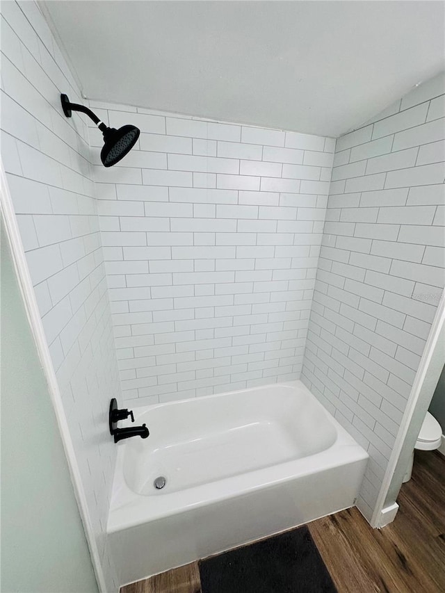 5654 12th St, Zephyrhills, FL 33542 - full bathroom featuring wood finished floors, toilet, and bathtub / shower combination