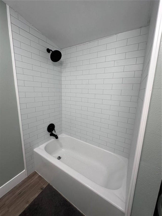 5654 12th St, Zephyrhills, FL 33542 - full bath featuring wood finished floors,  shower combination, and baseboards