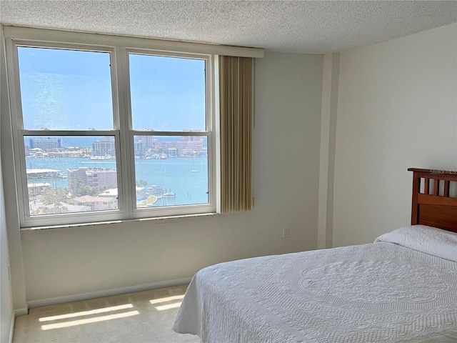 400 Island Way Unit 1402, Clearwater Beach, FL 33767 - carpeted bedroom with baseboards and a textured ceiling