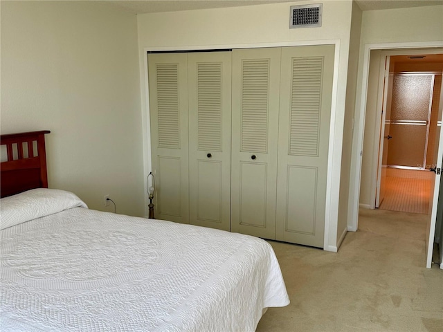 400 Island Way Unit 1402, Clearwater Beach, FL 33767 - bedroom featuring a closet, light carpet, and baseboards