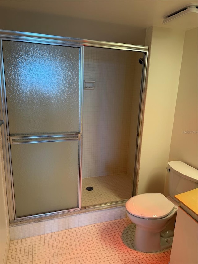 400 Island Way Unit 1402, Clearwater Beach, FL 33767 - bathroom with vanity, a stall shower, tile patterned floors, and toilet