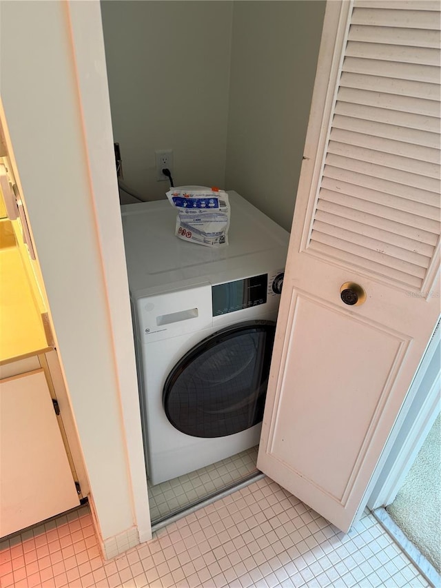 400 Island Way Unit 1402, Clearwater Beach, FL 33767 - laundry area with washer / clothes dryer and light tile patterned flooring