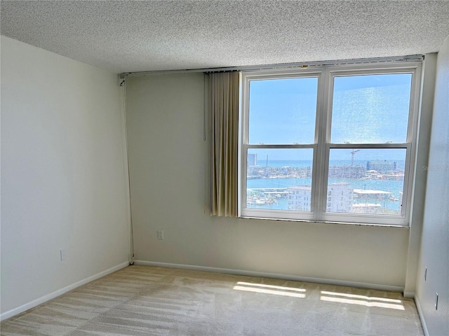 400 Island Way Unit 1402, Clearwater Beach, FL 33767 - carpeted spare room featuring a textured ceiling and baseboards