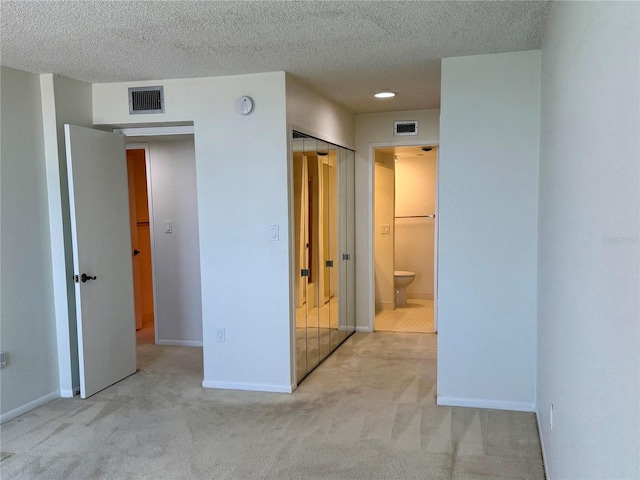 400 Island Way Unit 1402, Clearwater Beach, FL 33767 - unfurnished bedroom featuring carpet floors, a textured ceiling, baseboards, and ensuite bath