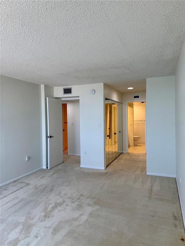 400 Island Way Unit 1402, Clearwater Beach, FL 33767 - spare room featuring carpet, a textured ceiling, and baseboards