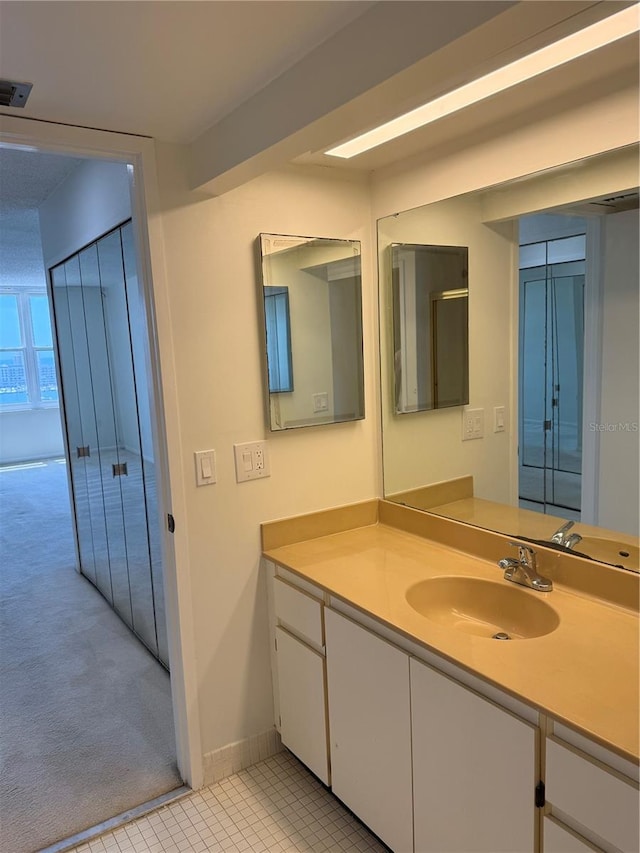 400 Island Way Unit 1402, Clearwater Beach, FL 33767 - bathroom featuring vanity, baseboards, and tile patterned flooring