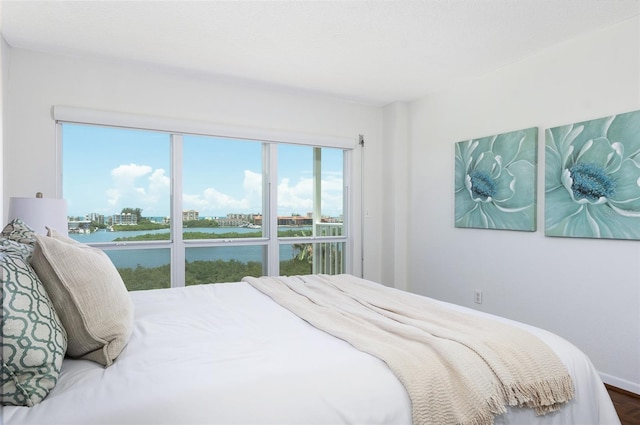9000 Commodore Dr Unit 606, Seminole, FL 33776 - bedroom with a water view and wood finished floors