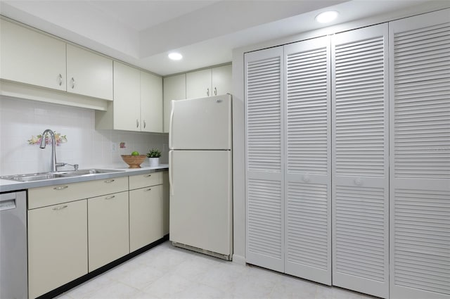 9000 Commodore Dr Unit 606, Seminole, FL 33776 - kitchen featuring freestanding refrigerator, stainless steel dishwasher, light countertops, recessed lighting, and decorative backsplash