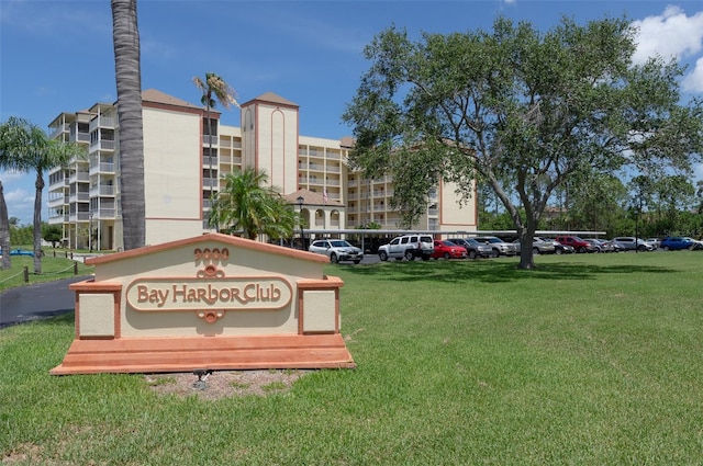 9000 Commodore Dr Unit 606, Seminole, FL 33776 - community / neighborhood sign with uncovered parking and a lawn