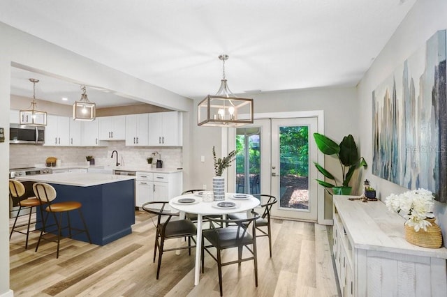 7208 N Ola Ave, Tampa, FL 33604 - dining space featuring light wood finished floors and a chandelier