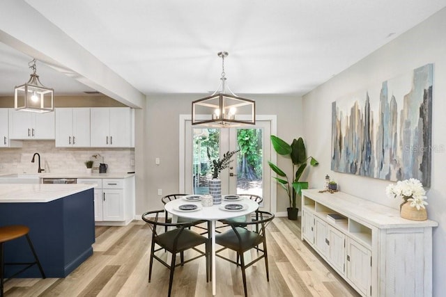 7208 N Ola Ave, Tampa, FL 33604 - dining room with light wood-type flooring, a chandelier, and baseboards