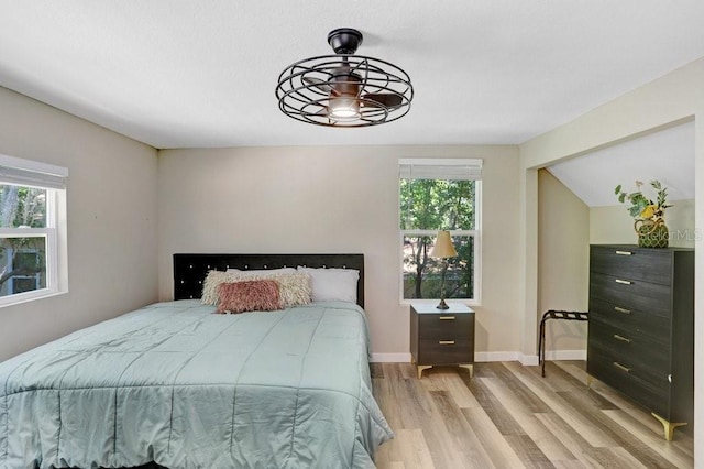 7208 N Ola Ave, Tampa, FL 33604 - bedroom featuring light wood-style floors, baseboards, and vaulted ceiling