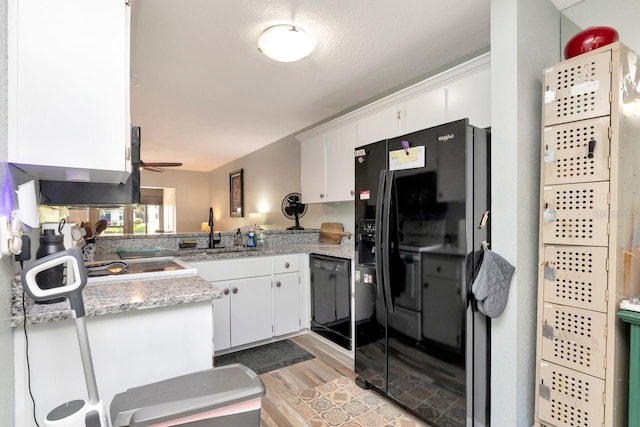 11201 122nd Ave Unit 167, Largo, FL 33778 - kitchen with black appliances, white cabinetry, light wood-style floors, and ceiling fan