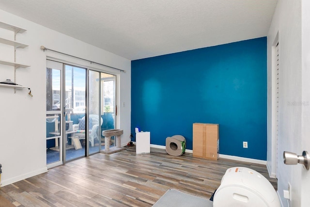 11201 122nd Ave Unit 167, Largo, FL 33778 - spare room featuring wood finished floors and a textured ceiling