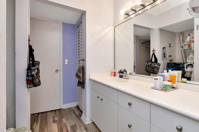 11201 122nd Ave Unit 167, Largo, FL 33778 - bathroom featuring wood finished floors and vanity