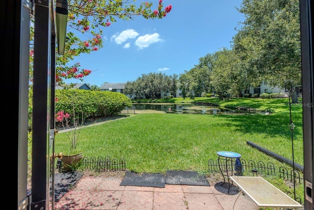 11201 122nd Ave Unit 167, Largo, FL 33778 - view of grassy yard with a water view and a patio area