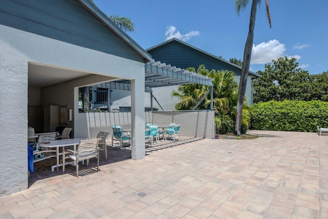 11201 122nd Ave Unit 167, Largo, FL 33778 - view of patio / terrace featuring outdoor dining area and a pergola