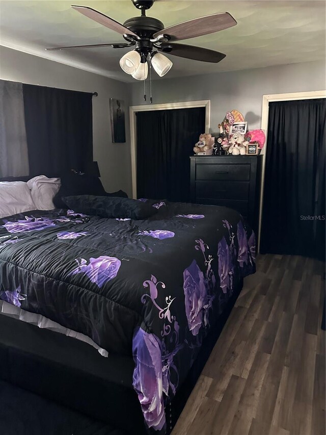 2198 Academy Dr, Clearwater, FL 33764 - bedroom with wood finished floors and ceiling fan