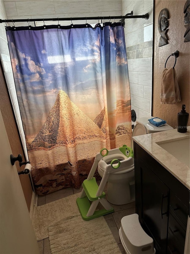 2198 Academy Dr, Clearwater, FL 33764 - bathroom with toilet, vanity, shower / tub combo with curtain, and tile patterned floors