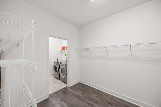 17668 Bright Wheat Dr, Lithia, FL 33547 - washroom featuring washing machine and dryer, baseboards, and dark wood-type flooring