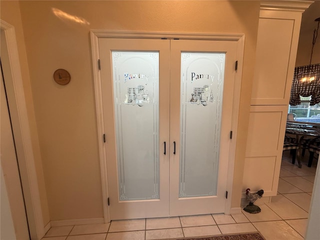 13133 Roseanna Dr, Spring Hill, FL 34609 - entrance foyer featuring light tile patterned flooring, baseboards, and french doors