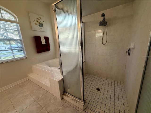 13133 Roseanna Dr, Spring Hill, FL 34609 - full bath featuring a shower stall, tile patterned flooring, a bath, and baseboards
