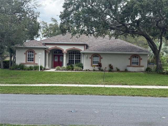 13133 Roseanna Dr, Spring Hill, FL 34609 - single story home featuring stucco siding, a front lawn, and roof with shingles