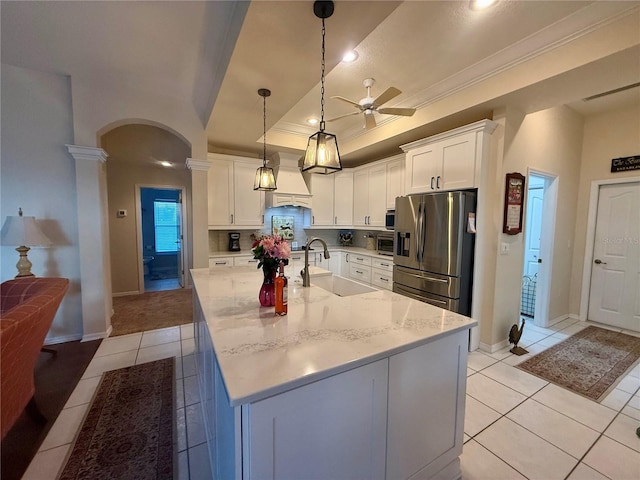 13133 Roseanna Dr, Spring Hill, FL 34609 - kitchen featuring stainless steel fridge with ice dispenser, ceiling fan, a sink, arched walkways, and light tile patterned floors