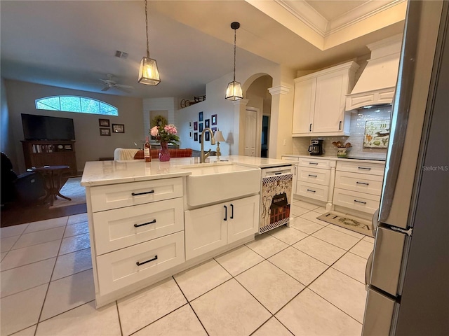 13133 Roseanna Dr, Spring Hill, FL 34609 - kitchen with a sink, dishwasher, arched walkways, crown molding, and light tile patterned floors