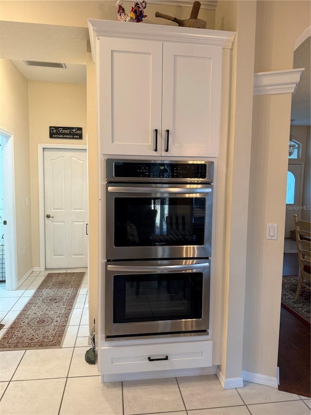 13133 Roseanna Dr, Spring Hill, FL 34609 - detailed view of stainless steel double oven, white cabinets, and baseboards